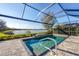 Beautiful pool with lake view and a safety handrail in a screened enclosure for enhanced safety at 13145 Amerigo Ln, Venice, FL 34293