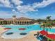 Large community pool with lounge chairs, umbrellas, and lush landscaping creating a resort-like atmosphere at 13145 Amerigo Ln, Venice, FL 34293