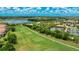 An aerial shot of the verdant community golf course and tennis courts, complete with lake views at 13719 Messina Loop # 101, Lakewood Ranch, FL 34211