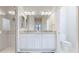 Bright bathroom with double sinks, granite countertops, and tiled shower at 13719 Messina Loop # 101, Lakewood Ranch, FL 34211