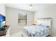 Comfortable bedroom with a TV, a window, and a warm bedside lamp at 13719 Messina Loop # 101, Lakewood Ranch, FL 34211