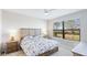 Bright bedroom with a large window and a comfortable bed at 13719 Messina Loop # 101, Lakewood Ranch, FL 34211