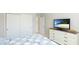 Bedroom with TV and double door closet at 13719 Messina Loop # 101, Lakewood Ranch, FL 34211