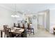 Dining area and kitchen bar with seating, creating an inviting and connected living space at 13719 Messina Loop # 101, Lakewood Ranch, FL 34211