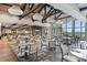 Spacious dining area with wood beams, large windows and stylish pendant lighting at 13719 Messina Loop # 101, Lakewood Ranch, FL 34211