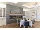 Elegant dining area with a fireplace, wine rack, modern decor and designer lighting at 13719 Messina Loop # 101, Lakewood Ranch, FL 34211