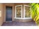 Inviting front entrance with a black door, large windows and a charming welcome mat at 13719 Messina Loop # 101, Lakewood Ranch, FL 34211