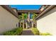 Beautiful entrance to the condominium with manicured landscaping and a lovely path at 13719 Messina Loop # 101, Lakewood Ranch, FL 34211