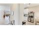 Bright hallway leading to the kitchen and living room with modern decor and tile flooring at 13719 Messina Loop # 101, Lakewood Ranch, FL 34211
