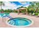 Inviting hot tub surrounded by lounge chairs and cabanas for relaxation and comfort at 13719 Messina Loop # 101, Lakewood Ranch, FL 34211