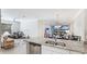 Open-concept kitchen with granite countertops and stainless steel appliances flows into living spaces at 13719 Messina Loop # 101, Lakewood Ranch, FL 34211