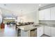 Open-concept kitchen with granite countertops offers seamless flow into the dining and living areas at 13719 Messina Loop # 101, Lakewood Ranch, FL 34211