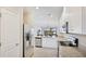 Modern kitchen with stainless steel appliances, white cabinets and granite countertops at 13719 Messina Loop # 101, Lakewood Ranch, FL 34211