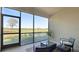 Enclosed patio with seating area offering a view of the lush landscaping and community at 13719 Messina Loop # 101, Lakewood Ranch, FL 34211
