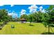 Community playground area with play equipment, a gazebo with seating, and surrounded by lush green grass and trees at 13719 Messina Loop # 101, Lakewood Ranch, FL 34211