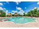 Beautiful pool area with canopies, seating, and palm trees against a vibrant blue sky with fluffy white clouds at 13719 Messina Loop # 101, Lakewood Ranch, FL 34211