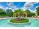 Stunning pool featuring an island with lush palm trees and landscaping, perfect for relaxation at 13719 Messina Loop # 101, Lakewood Ranch, FL 34211