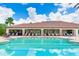 Community pool featuring an outdoor covered seating area for dining and lounging at 13719 Messina Loop # 101, Lakewood Ranch, FL 34211