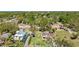 An aerial shot showcases the home's location within a lush, green neighborhood at 1406 5Th W St, Palmetto, FL 34221