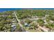 Expansive aerial view features this home's location near the water in a lush, green, treed area at 1406 5Th W St, Palmetto, FL 34221