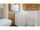 Bathroom featuring a sink, toilet, and wooden door at 1406 5Th W St, Palmetto, FL 34221