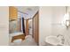 Bright bathroom featuring tiled walls, a wood trimmed tub, and a stackable washer and dryer at 1406 5Th W St, Palmetto, FL 34221