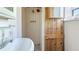 Shower with white tiles, a sink, and a wooden door with a rustic design at 1406 5Th W St, Palmetto, FL 34221