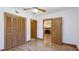Bright bedroom features a ceiling fan, closet, and light wood flooring at 1406 5Th W St, Palmetto, FL 34221