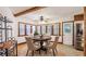 Cozy dining room featuring a beamed ceiling, wood floors, and adjacent kitchen at 1406 5Th W St, Palmetto, FL 34221