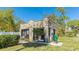Charming stone cottage featuring black trim and a well maintained lawn at 1406 5Th W St, Palmetto, FL 34221