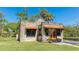 Delightful stone house featuring orange tile accents and a meticulously maintained lawn on a sunny day at 1406 5Th W St, Palmetto, FL 34221