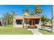 Charming stone home with unique architecture, bright orange accents, and well-kept front lawn at 1406 5Th W St, Palmetto, FL 34221