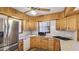 Well-lit kitchen featuring wood cabinets, stainless steel appliances, and a view from the window at 1406 5Th W St, Palmetto, FL 34221