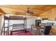 Efficient living area with wood ceilings, a bunk bed, and a small kitchen at 1406 5Th W St, Palmetto, FL 34221