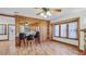 Open concept living room featuring wood paneling, breakfast bar and window with light-filled view at 1406 5Th W St, Palmetto, FL 34221