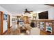 Open concept living area with hardwood floors, a stone fireplace, and seamless flow to other rooms at 1406 5Th W St, Palmetto, FL 34221