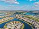 Community aerial view showcases waterfront homes in a golfing community surrounded by manicured grounds at 15430 Blackmoor Ter, Lakewood Ranch, FL 34202