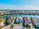 Aerial view showcasing homes around a lake in a golf course community with tropical landscaping at 15430 Blackmoor Ter, Lakewood Ranch, FL 34202