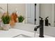 Bright bathroom features a white vanity with storage, modern black fixtures, and light walls at 15430 Blackmoor Ter, Lakewood Ranch, FL 34202