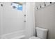 Bright bathroom features a white tub/shower combo, a window, and light walls at 15430 Blackmoor Ter, Lakewood Ranch, FL 34202
