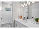 Bright bathroom features a white vanity with storage, modern fixtures, and shower/tub at 15430 Blackmoor Ter, Lakewood Ranch, FL 34202