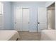 bedroom features a closet with sliding doors and a view into another room at 15430 Blackmoor Ter, Lakewood Ranch, FL 34202
