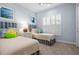 bedroom features twin beds, blue accents, a window with shutters, and neutral carpet at 15430 Blackmoor Ter, Lakewood Ranch, FL 34202