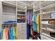 Spacious walk-in closet with custom shelving, storage options, and well-organized clothing racks at 15430 Blackmoor Ter, Lakewood Ranch, FL 34202