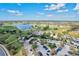 Aerial view of the clubhouse surrounded by a golf course, parking lot, and manicured landscaping at 15430 Blackmoor Ter, Lakewood Ranch, FL 34202