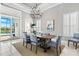 Dining room with a chandelier, table with seating for six, and view of the pool at 15430 Blackmoor Ter, Lakewood Ranch, FL 34202
