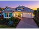 Charming single-story home boasts lush landscaping, brick driveway, and inviting curb appeal at 15430 Blackmoor Ter, Lakewood Ranch, FL 34202