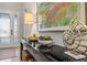Close-up of foyer console table displays decorative shell, succulents, and a painting at 15430 Blackmoor Ter, Lakewood Ranch, FL 34202