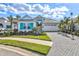 Well-maintained single-Gathering home with turquoise shutters, a paver driveway, and manicured landscaping at 15430 Blackmoor Ter, Lakewood Ranch, FL 34202