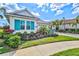 Attractive single-Gathering home with turquoise shutters, a paver driveway, and vibrant landscaping at 15430 Blackmoor Ter, Lakewood Ranch, FL 34202